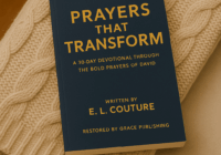 A paperback copy of Prayers That Transform by E. L. Couture resting on a beige cable-knit throw draped over a soft armchair, creating a warm and cozy setting for a Christian devotional Christmas gift that encourages deeper prayer and faith.